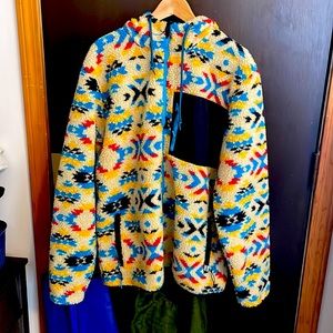 sherpa material jacket/hoodie. fairly warm and is true to size. multiple pockets